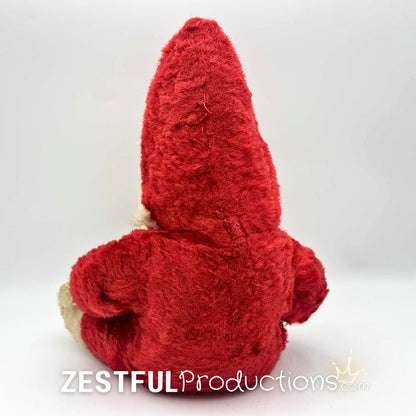 Back view of vintage Santa Claus plush doll collectible with pointed red hood and plush body. Rushton style 1950s Christmas decor piece featuring classic mid century holiday character and nostalgic retro styling.