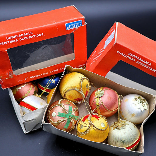 Vintage satin Christmas ornaments with original Montgomery Ward box packaging, showing colorful retro ornaments with gold detailing and classic mid century holiday decor styling