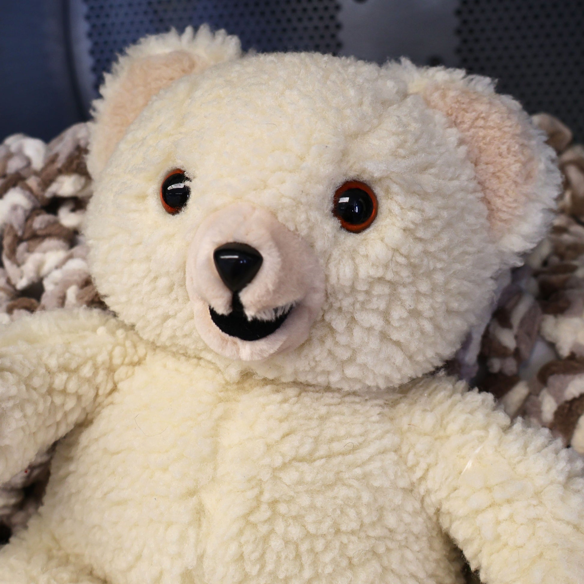 Close-up portrait of an original 1986 Lever Brothers Snuggle Bear featuring expressive brown safety eyes, soft ivory plush, and a classic smiling expression. Perfect for collectors of vintage advertising mascots, retro plush toys, and cozy nursery or shelf decor.