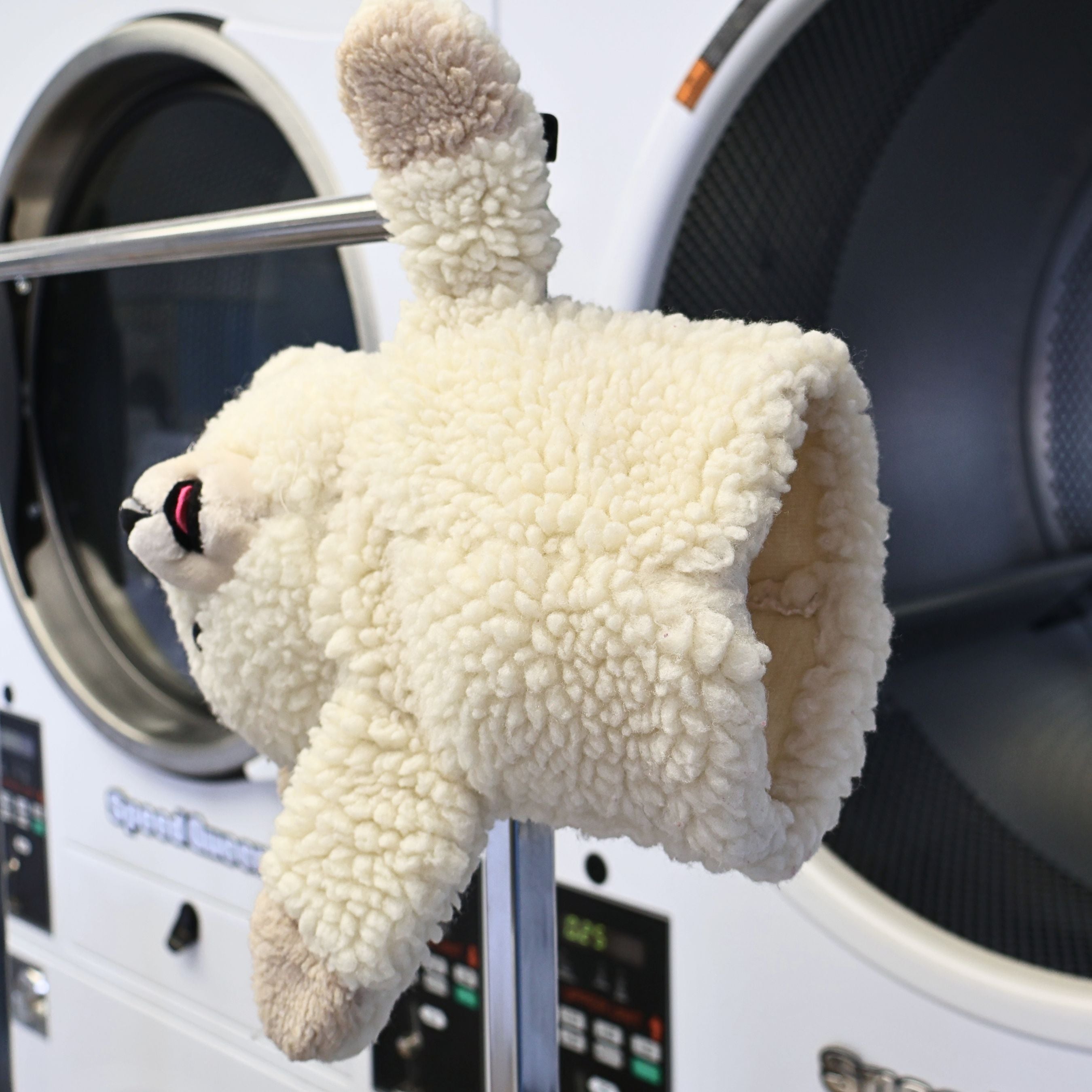Side profile of a vintage 1986 Snuggle Bear hand puppet by Lever Brothers showing the plush texture, embroidered facial features, and soft cream sherpa fabric. A nostalgic advertising collectible perfect for vintage plush collections and cozy laundry room decorating.
