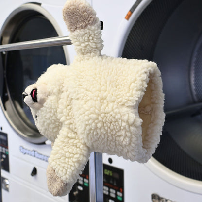 Side profile of a vintage 1986 Snuggle Bear hand puppet by Lever Brothers showing the plush texture, embroidered facial features, and soft cream sherpa fabric. A nostalgic advertising collectible perfect for vintage plush collections and cozy laundry room decorating.