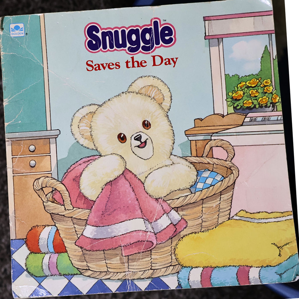 Vintage 1987 Snuggle Saves the Day storybook by Lever Brothers and Golden Books featuring the iconic Snuggle Bear on the illustrated front cover. Original advertising collectible in fair vintage condition, perfect for nostalgic laundry room decor, paper ephemera collections, and advertising memorabilia displays.