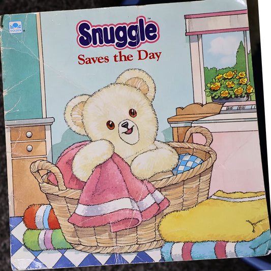 Vintage 1987 Snuggle Saves the Day storybook by Lever Brothers and Golden Books featuring the iconic Snuggle Bear on the illustrated front cover. Original advertising collectible in fair vintage condition, perfect for nostalgic laundry room decor, paper ephemera collections, and advertising memorabilia displays.