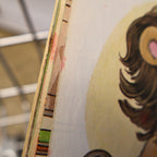 Close-up photograph highlighting the age-related wear of the vintage Snuggle Saves the Day storybook. Detailed condition view showing shelf wear, storage marks, and authentic vintage character while confirming the binding remains intact.