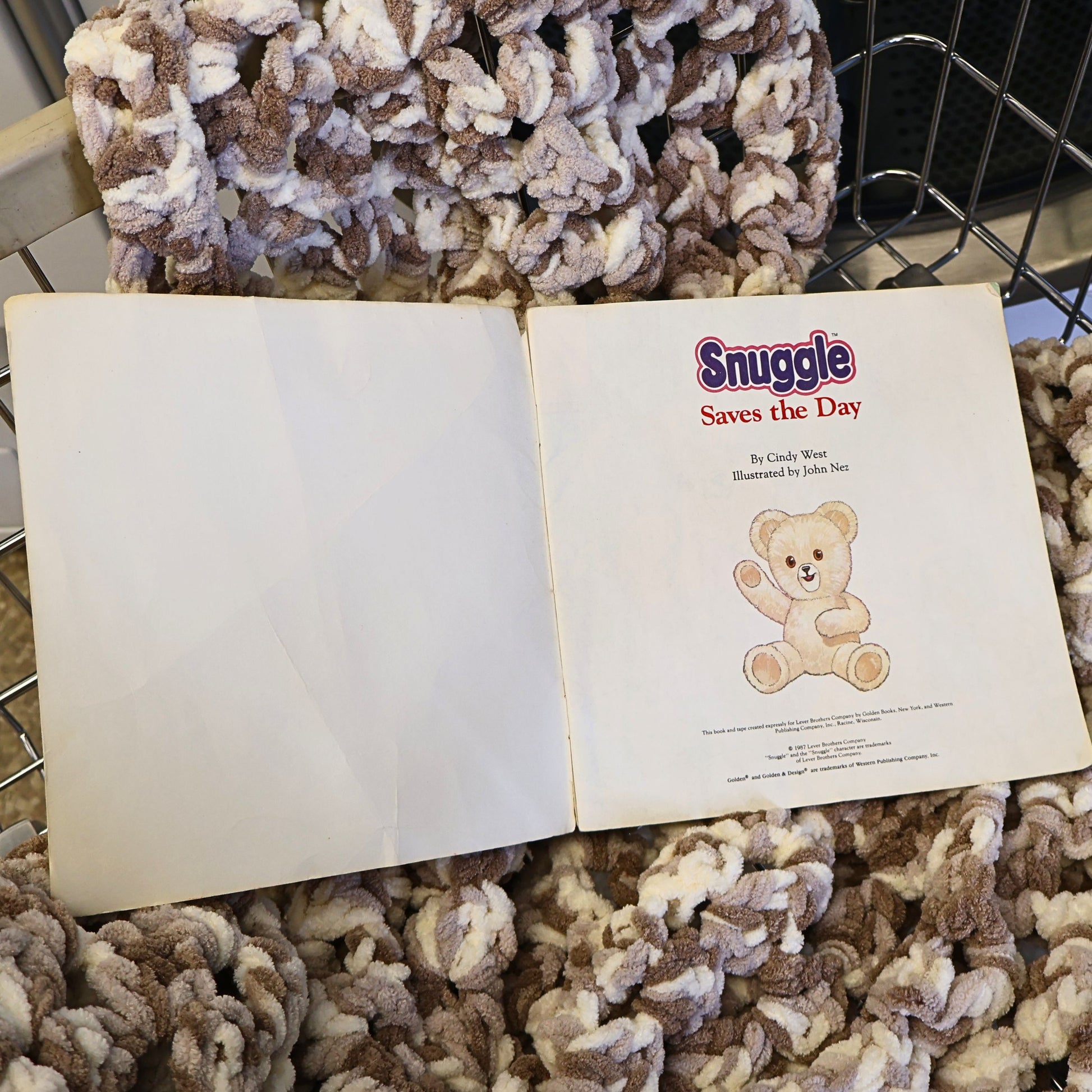 Vintage Snuggle Saves the Day storybook opened to display the title page and overall interior condition. Original 1987 Lever Brothers advertising collectible showing complete pages, intact binding, and authentic age-related wear consistent with decades of careful storage.