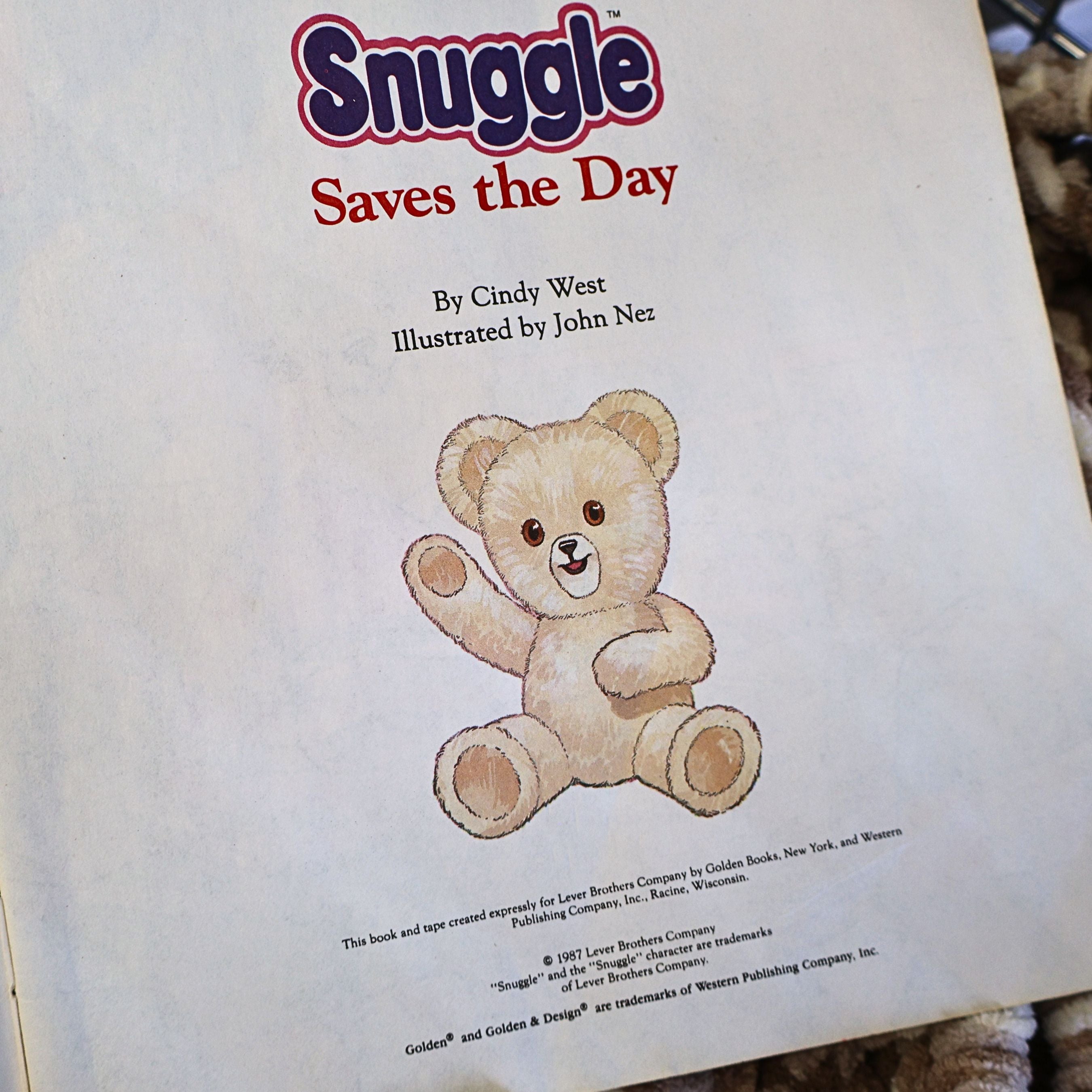 Title page from the original 1987 Snuggle Saves the Day storybook showing the Snuggle Bear illustration, publication credits, and classic Lever Brothers branding. A nostalgic Golden Books advertising collectible for vintage paper and household advertising enthusiasts.