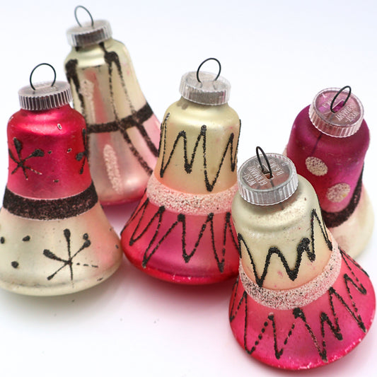 Vintage West Germany atomic bell ornaments with pink cream and black mercury glass finishes in mid century Christmas decor style