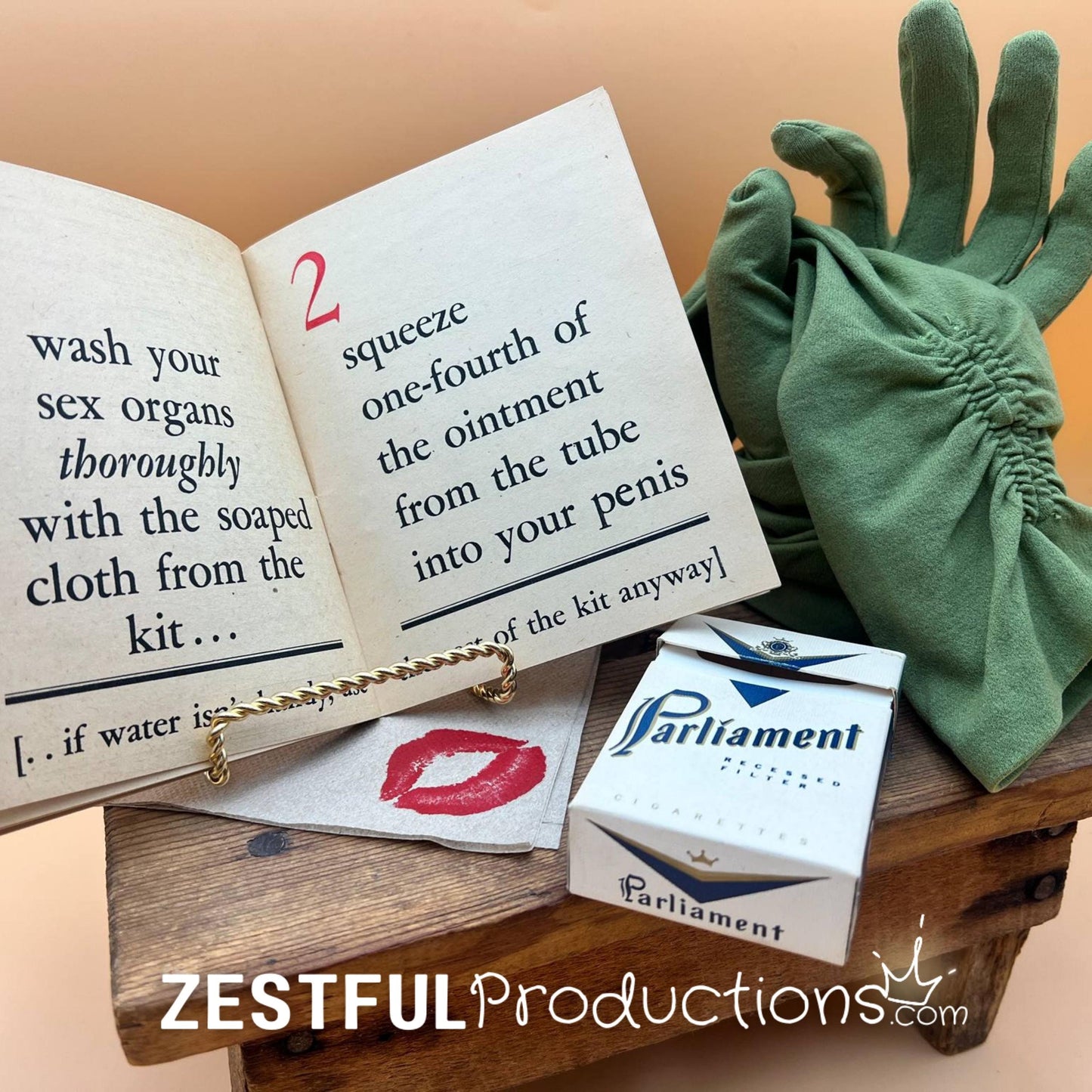 Curated WWII military ephemera vignette with green gloves and cigarette box