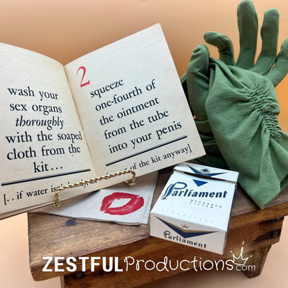 Curated WWII military ephemera vignette with green gloves and cigarette box