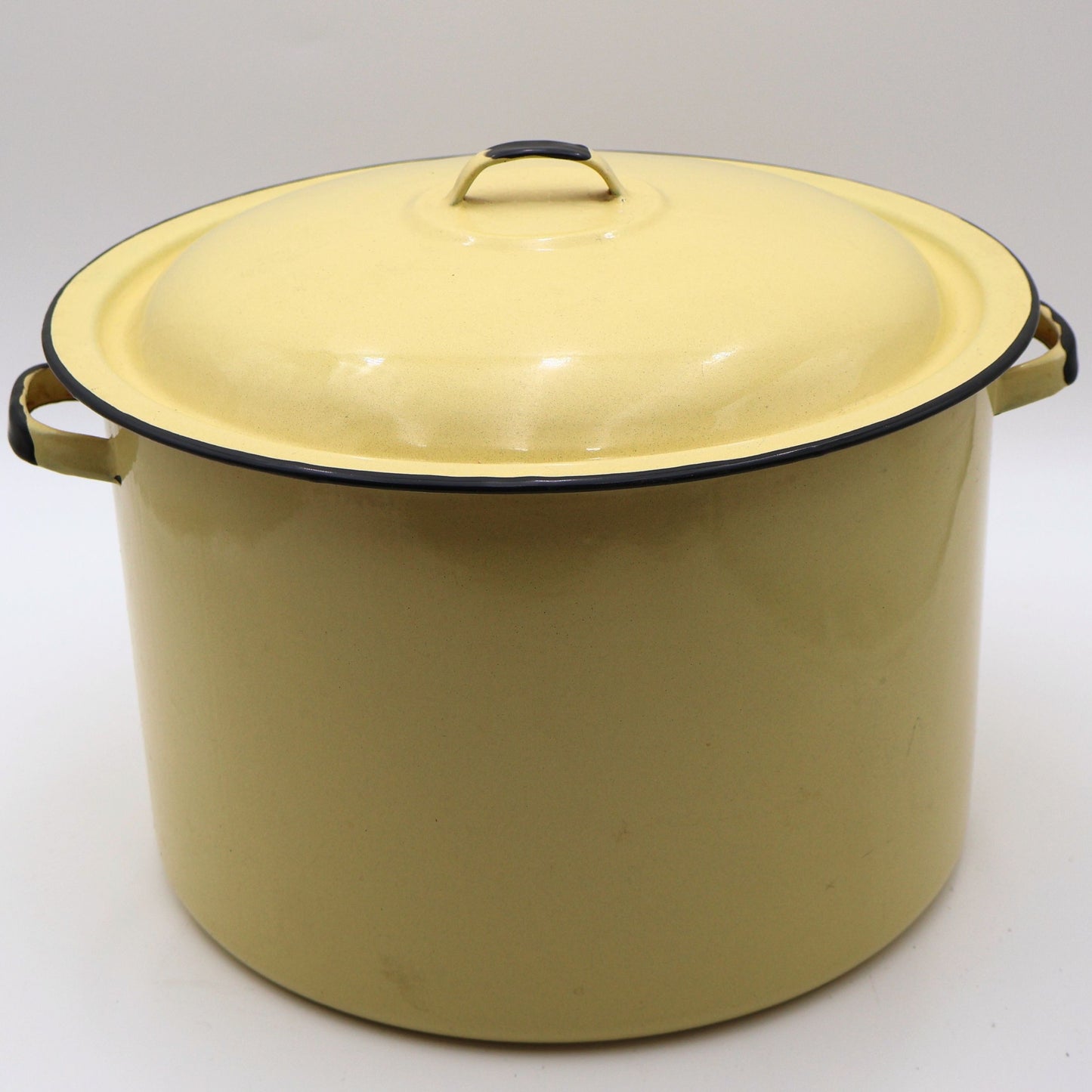 Vintage yellow enamelware stock pot with matching lid featuring a buttery yellow porcelain enamel finish, black rolled rim, and sturdy side handles. This large farmhouse kitchen collectible is perfect for cottagecore decor, rustic homes, and vintage kitchen styling.