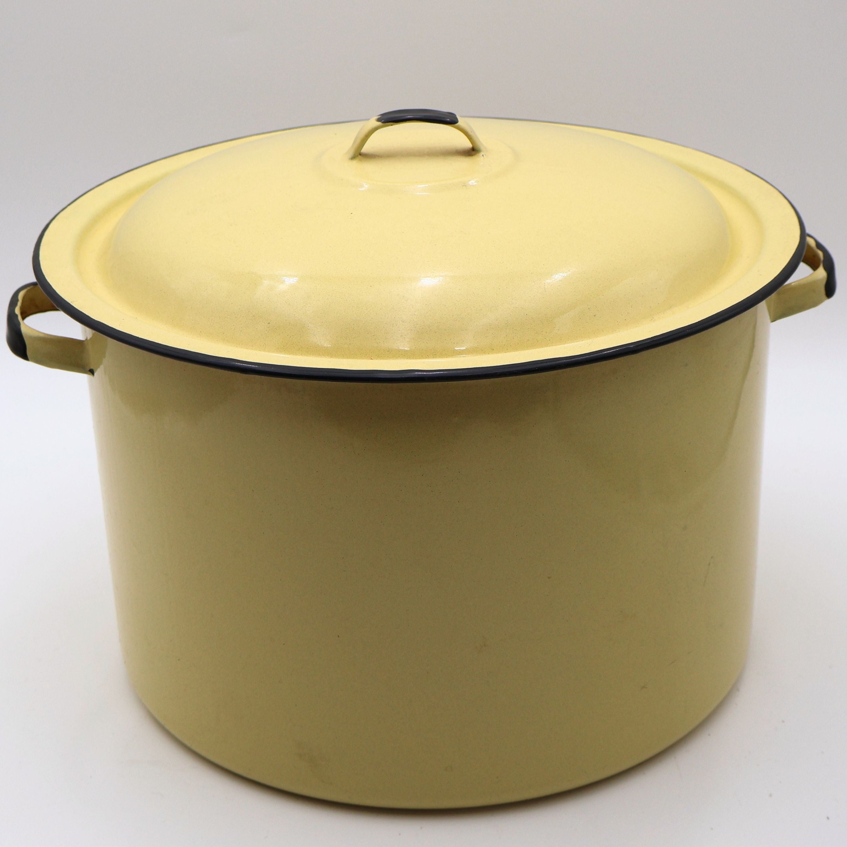 Vintage yellow enamelware stock pot with matching lid featuring a buttery yellow porcelain enamel finish, black rolled rim, and sturdy side handles. This large farmhouse kitchen collectible is perfect for cottagecore decor, rustic homes, and vintage kitchen styling.