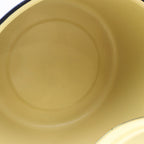 Interior view of a vintage yellow enamelware stock pot highlighting the smooth enamel-coated cooking surface and classic mid-century design. Perfect for farmhouse kitchens, country home decor, vintage displays, and collectible cookware.