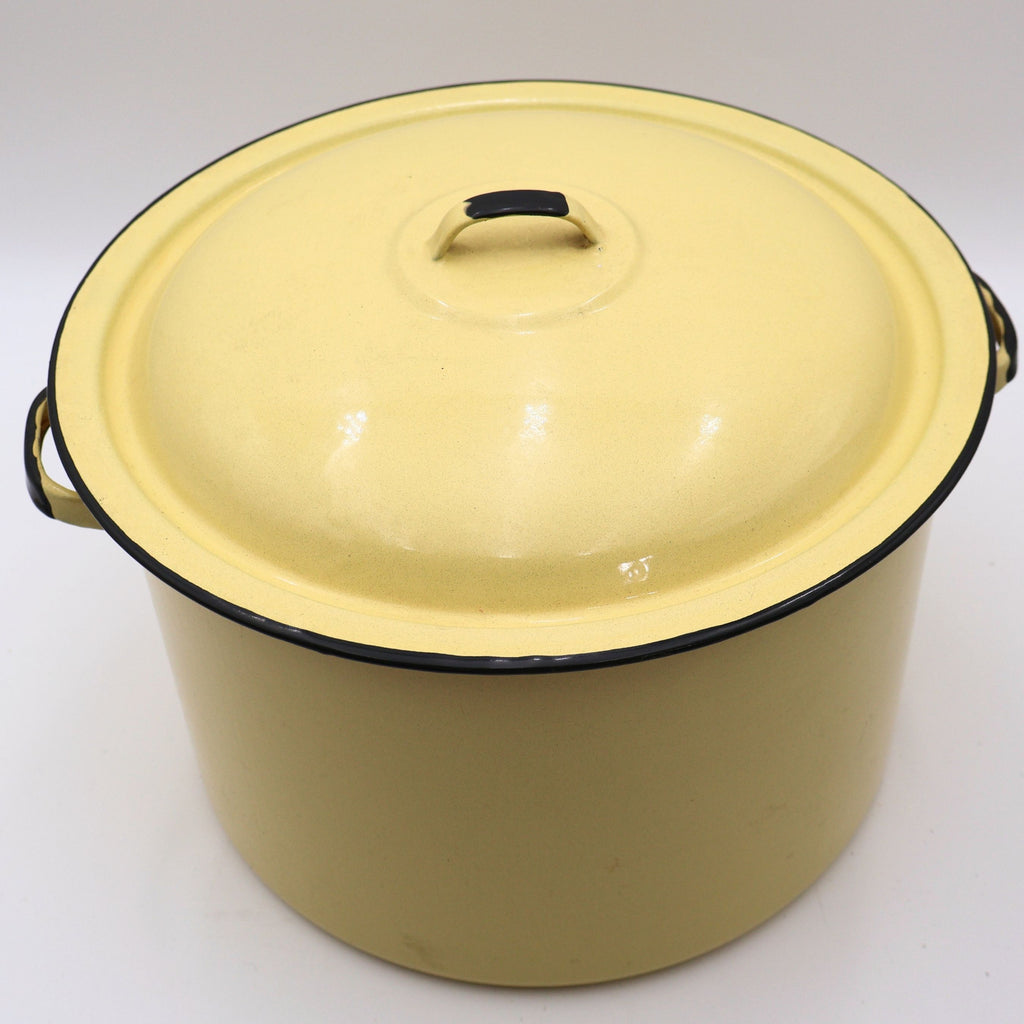 Top view of a vintage yellow enamelware stock pot with matching lid showcasing its classic domed lid, buttery yellow finish, and black trim. A timeless piece of farmhouse kitchen decor with authentic vintage character.