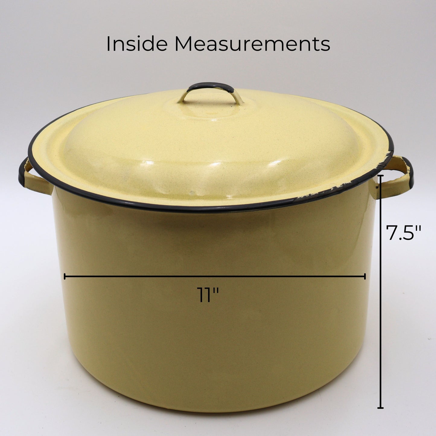 Vintage yellow enamelware stock pot shown with measurement reference displaying an approximate 11-inch diameter and 7.5-inch height. This large lidded farmhouse cookware piece makes a beautiful display in country kitchens, cottage homes, and vintage collections.