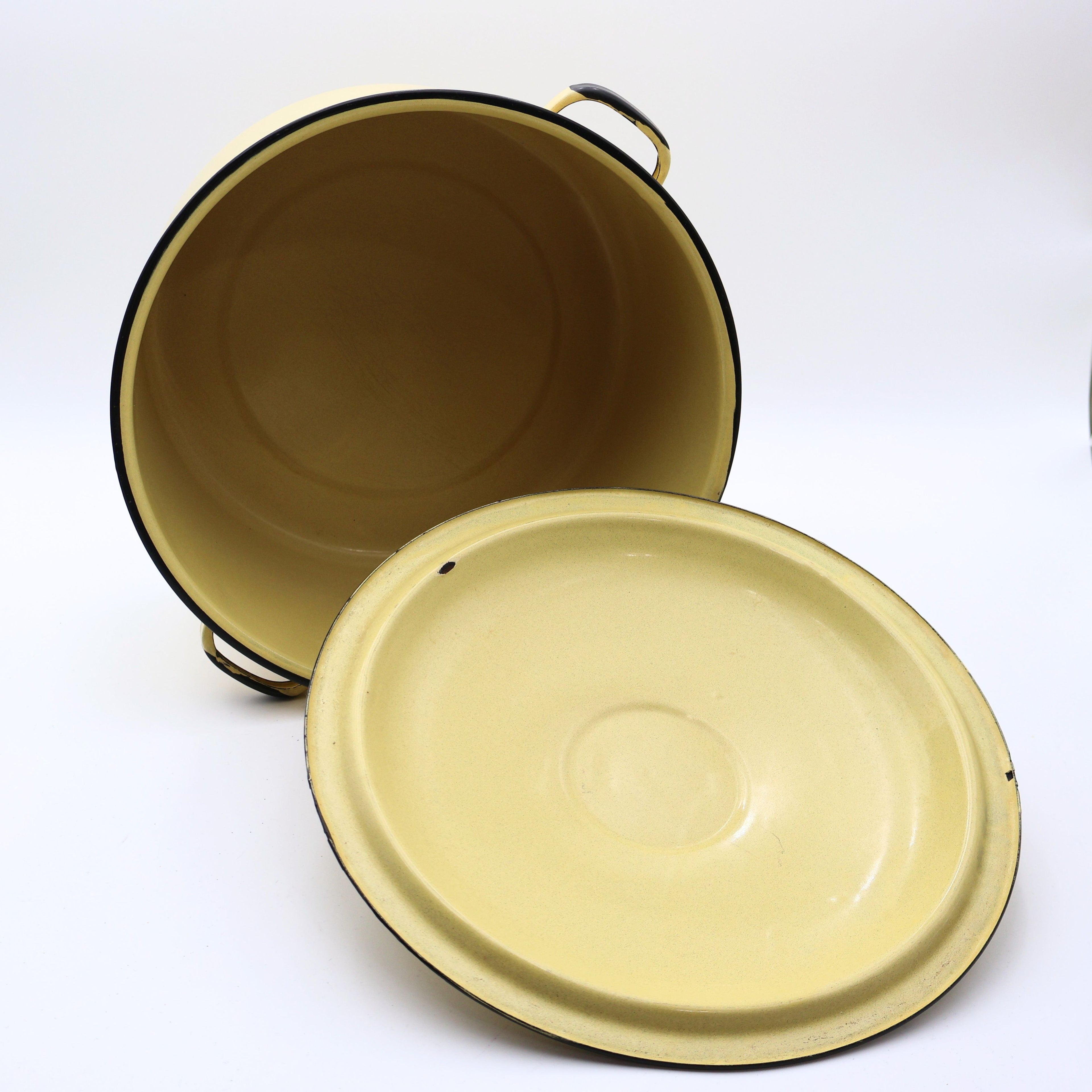 Vintage yellow enamelware stock pot displayed with the lid removed, revealing the clean enamel interior and spacious design. Ideal for farmhouse kitchen décor, vintage cookware collectors, cottagecore styling, or rustic home displays.