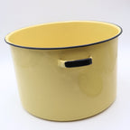 Side profile of a vintage yellow enamelware stock pot featuring classic loop handles, buttery yellow porcelain enamel, and timeless farmhouse styling. This one-of-a-kind vintage cookware piece adds warmth and nostalgia to any kitchen.