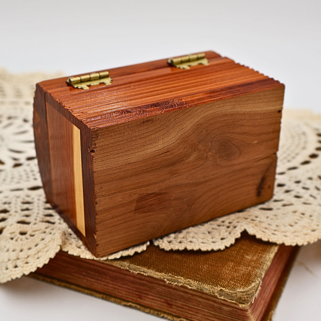 Bottom view of the vintage solid cedar keepsake box showing the natural wood construction, handcrafted joinery, and beautiful grain variation. The underside reflects the quality craftsmanship found throughout this Yellowstone National Park wooden souvenir box.