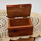Angled view of the open Yellowstone National Park cedar keepsake box highlighting the deep storage compartment, ribbed exterior detailing, and handcrafted cedar construction. The warm wood tones make it ideal for rustic cabin decor or vintage souvenir collections.