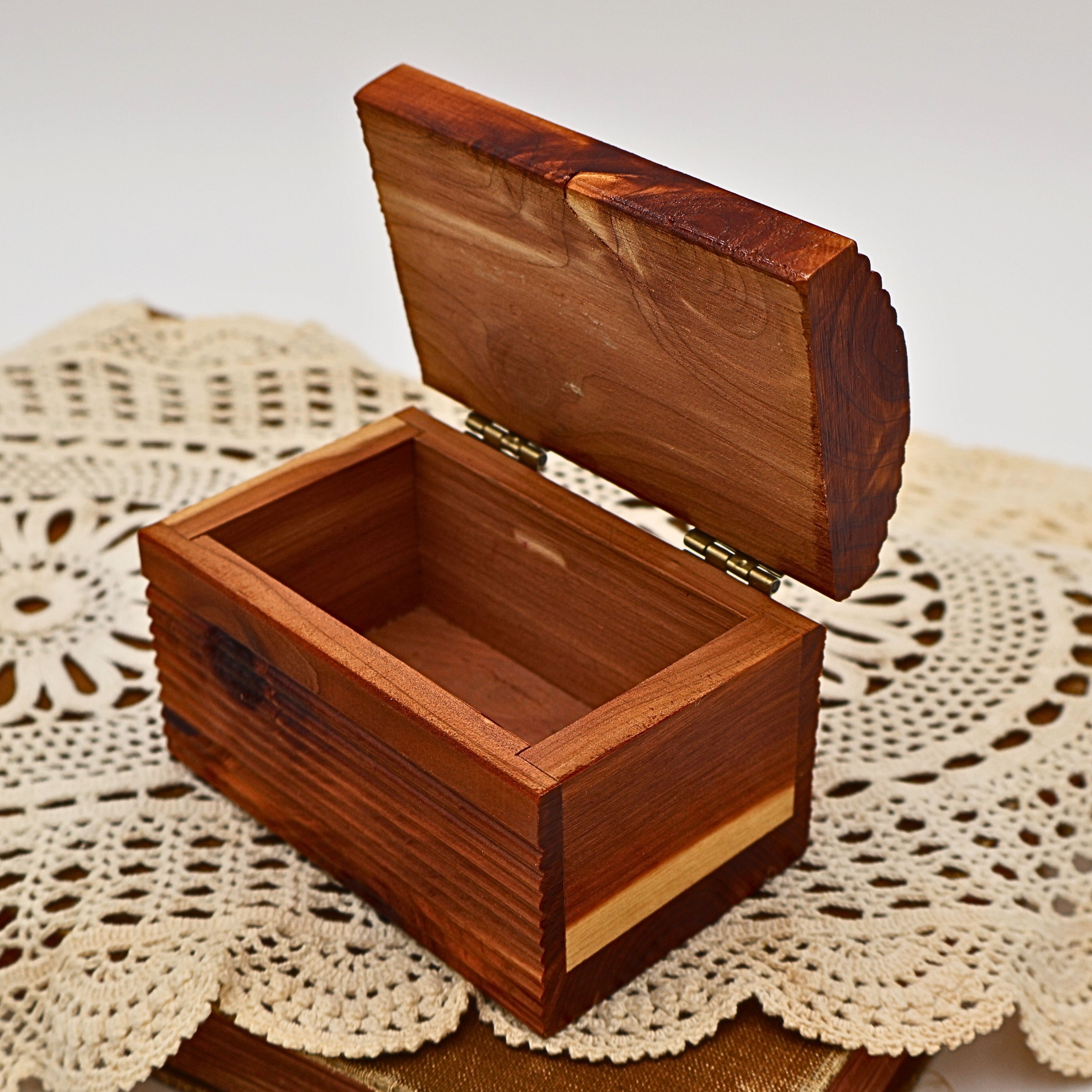 Vintage Yellowstone National Park cedar keepsake box displayed open to reveal its clean solid cedar interior and brass-tone hinges. The handcrafted wooden storage box offers space for jewelry, letters, small collectibles, or treasured travel memories.