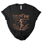 Black heather western graphic tee with copper cowgirl illustration and “I’m not big on social graces” text, edgy boutique t-shirt with vintage western style