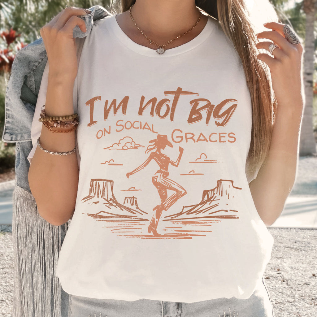 Woman wearing white western graphic tee with cowgirl design and relaxed fit, casual boutique outfit with vintage western style and neutral tones