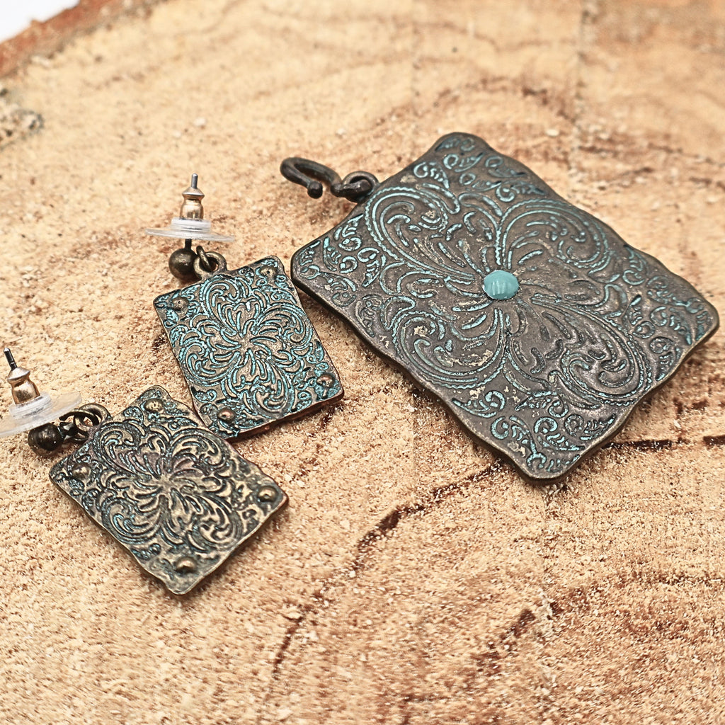 Backside view of Western longhorn jewelry set showing textured metal finish and construction details, turquoise patina earrings and pendant with engraved patterns and rustic finish, cowgirl jewelry set highlighting craftsmanship and durability, ideal for buyers wanting full detail of Western style accessories and Southwestern fashion pieces