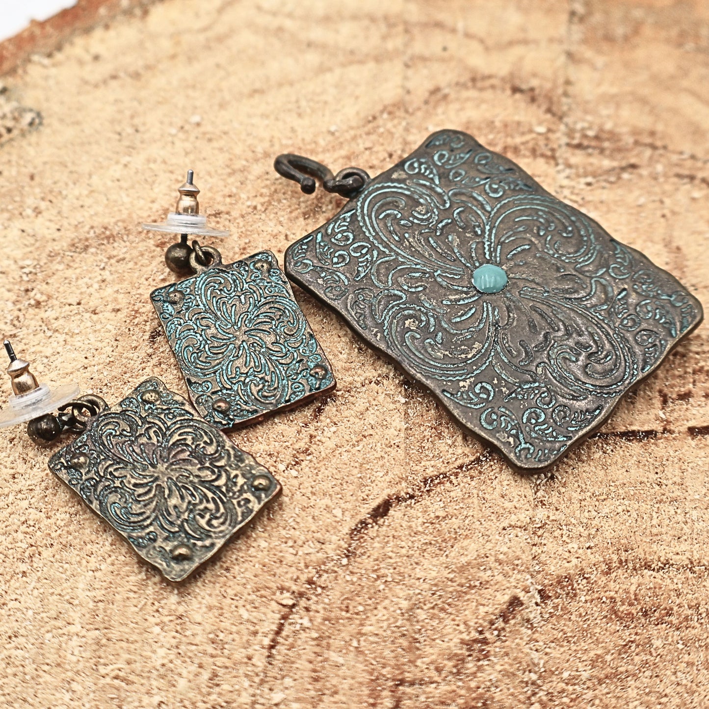Backside view of Western longhorn jewelry set showing textured metal finish and construction details, turquoise patina earrings and pendant with engraved patterns and rustic finish, cowgirl jewelry set highlighting craftsmanship and durability, ideal for buyers wanting full detail of Western style accessories and Southwestern fashion pieces