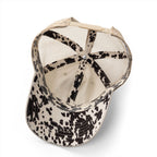 Interior view of cream western mesh-back trucker hat showing black and cream longhorn print undervisor and matching interior trim detail
