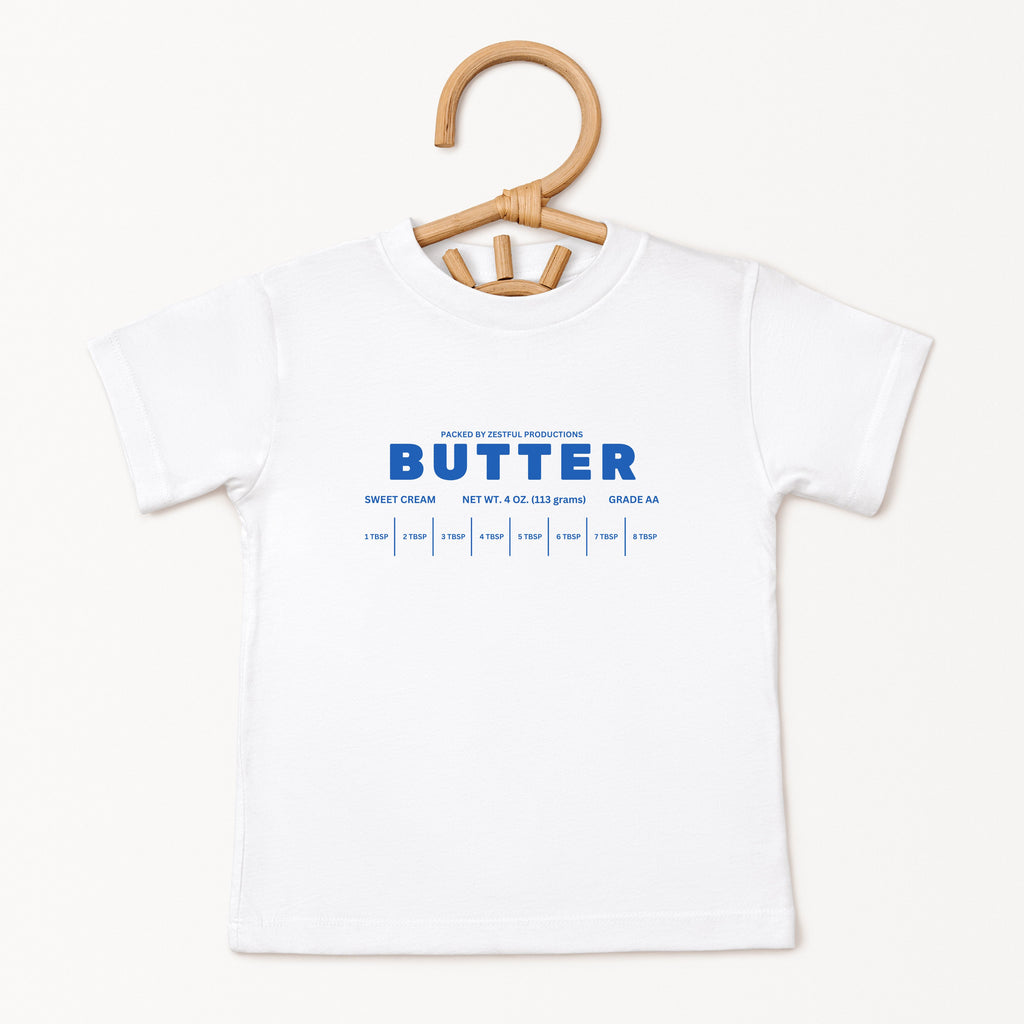White butter foodie kids shirt displayed on hanger with retro bakery inspired graphic design. Boutique toddler birthday apparel styled for preschool outfits, baking themes, family photos, and playful celebrations.