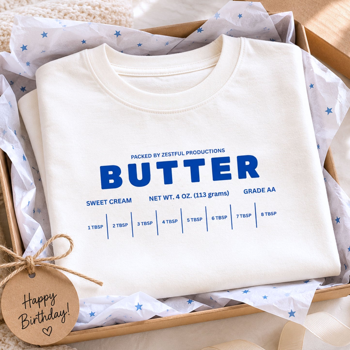 Folded white butter toddler shirt featuring retro sweet cream baking graphic and foodie inspired design. Boutique preschool party apparel styled for birthdays, baking themes, family photos, and trendy kids fashion.