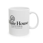 White ceramic coffee mug photographed with its handle on the right and the White House Cafeteria logo displayed in black. The design includes the restaurant's original 117 North 5th Street address in Bismarck, North Dakota.