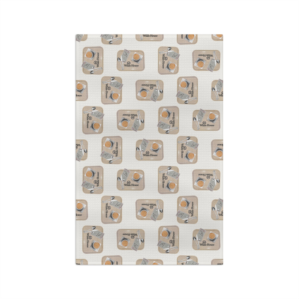 Full front view of the White House Cafeteria kitchen towel showing a tossed all-over pattern on a light oatmeal background. Each vintage tray includes coffee, silverware, a handwritten Cheese Buttons and caramel roll order, and the White House Cafeteria logo.