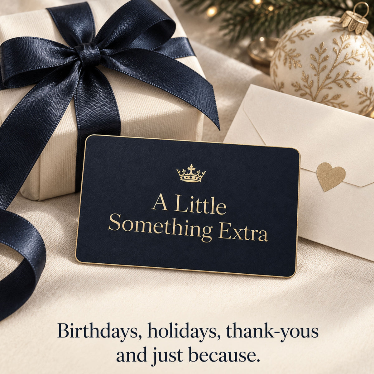 Navy and gold Zestful Productions gift card arranged with an ivory present tied in navy ribbon, a gold-accented holiday ornament and a cream envelope with a heart seal. The image suggests digital gifting for birthdays, holidays, thank-yous and just because.