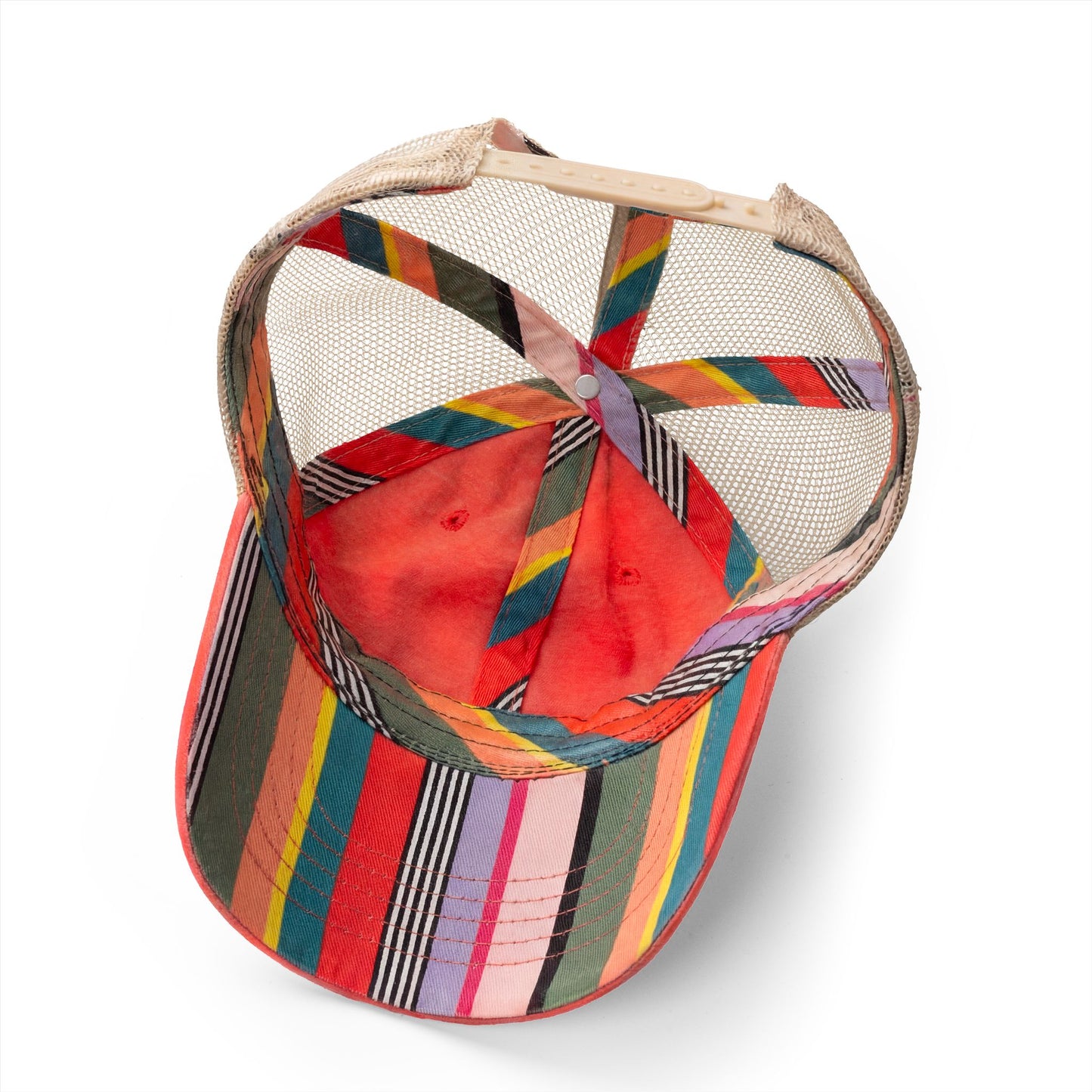 Inside view of coral trucker hat showing colorful striped underbrim and interior band detail