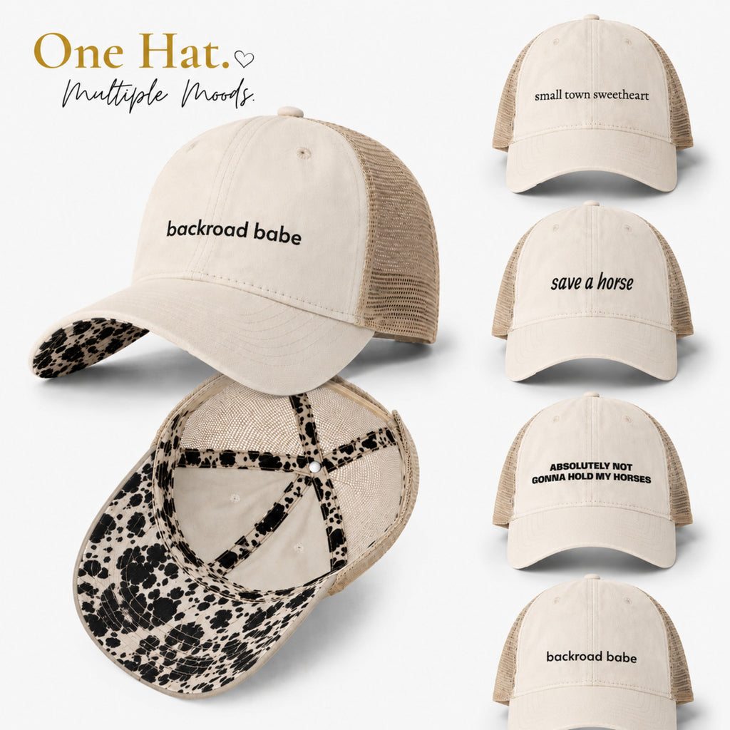 Cream western mesh-back ponytail trucker hat with cow print longhorn undervisor shown in multiple embroidered phrase variations including backroad babe and save a horse