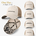 Cream western mesh-back ponytail trucker hat with cow print longhorn undervisor shown in multiple embroidered phrase variations including backroad babe and save a horse