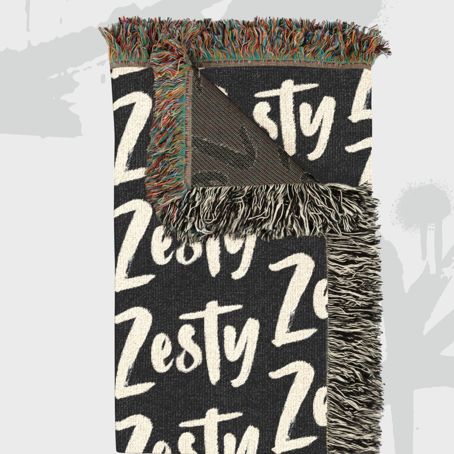 Zesty statement woven throw blanket with bold text pattern and colorful fringe